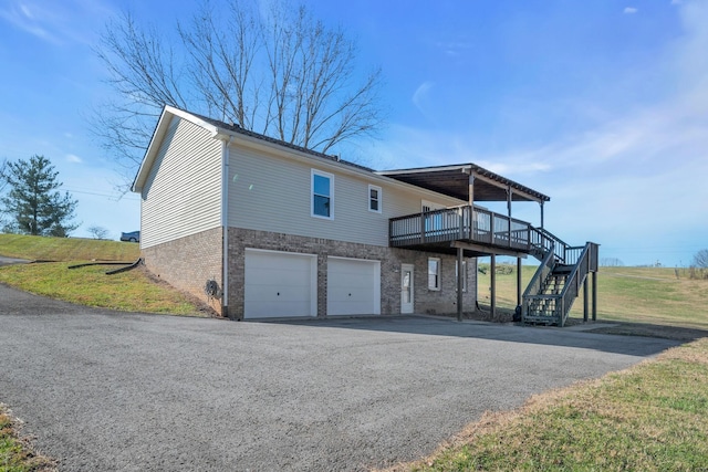 exterior space featuring a yard, a deck, and a garage