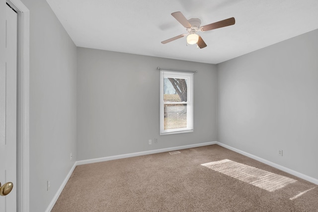 carpeted spare room with ceiling fan