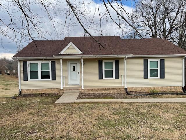 single story home featuring a front lawn