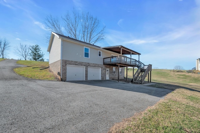 view of front of property with a front yard, a garage, and a deck