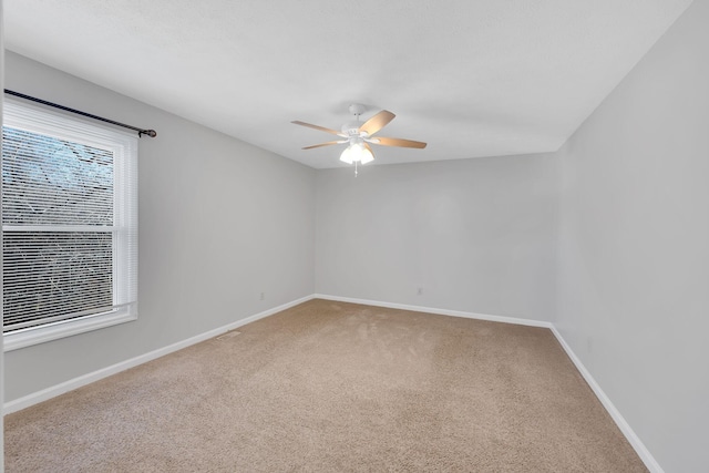 carpeted empty room featuring ceiling fan