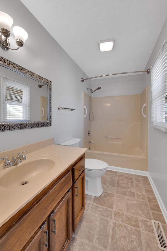 bathroom with vanity, a healthy amount of sunlight, and toilet