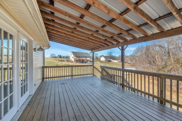 wooden deck featuring french doors and a lawn