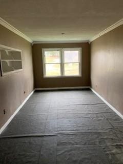 carpeted empty room featuring ornamental molding