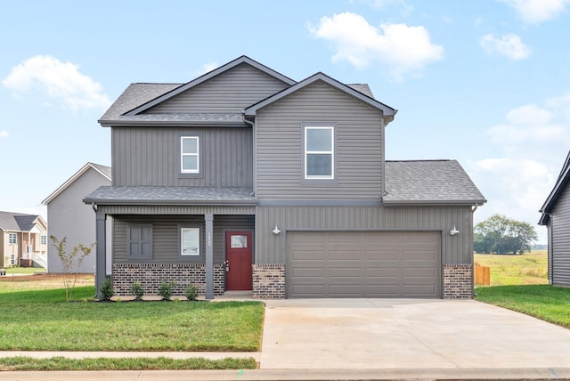 view of front of home featuring a front lawn and a garage