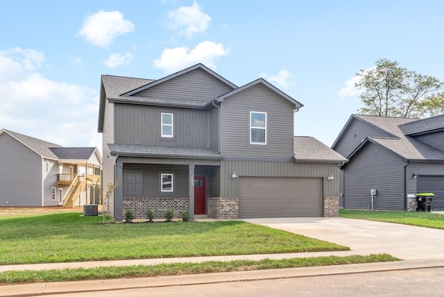 view of front of house featuring a garage, central air condition unit, and a front yard