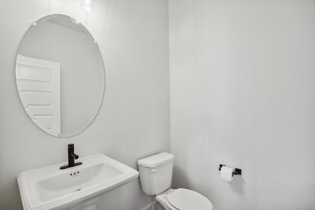 bathroom featuring toilet and sink