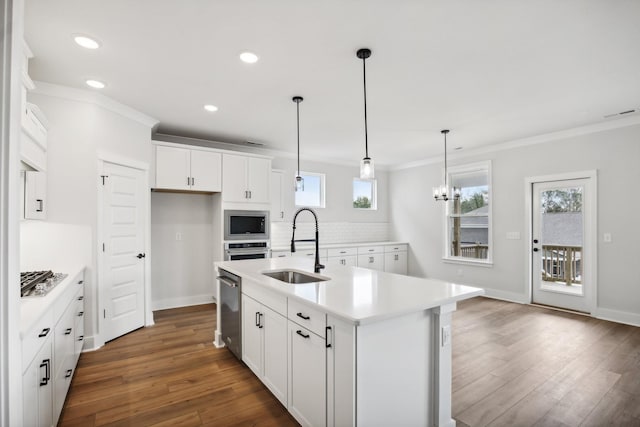 kitchen featuring white cabinetry, sink, dark hardwood / wood-style floors, backsplash, and a center island with sink