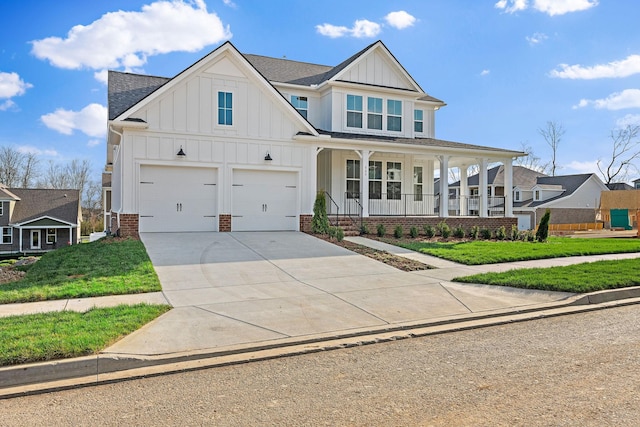 view of front of home featuring a front lawn, a porch, and a garage