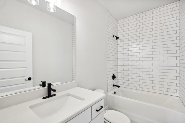 full bathroom with vanity, tiled shower / bath combo, and toilet