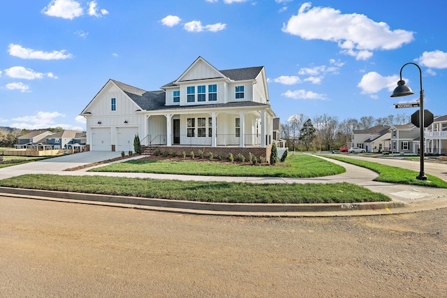 view of front of home featuring a front yard, a porch, and a garage