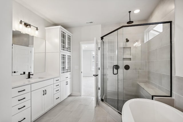 bathroom with plus walk in shower, vanity, and tile patterned floors