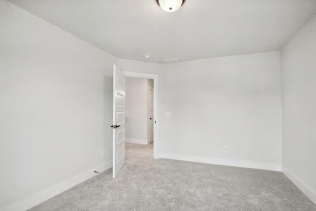 unfurnished room featuring light carpet