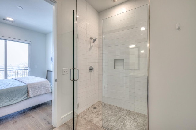 bathroom featuring wood-type flooring and walk in shower