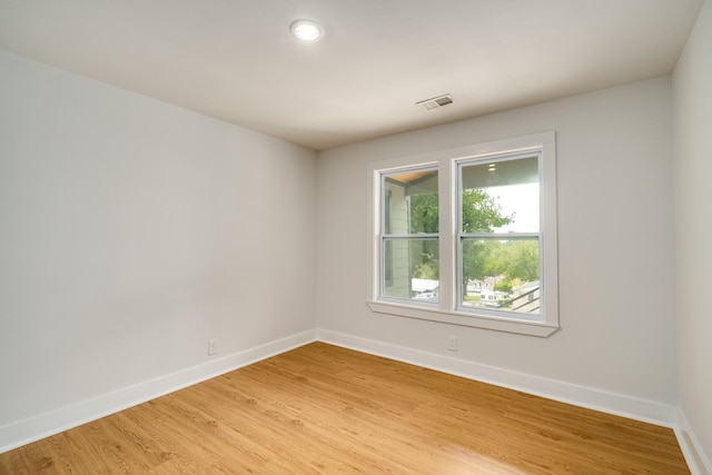 spare room with wood-type flooring