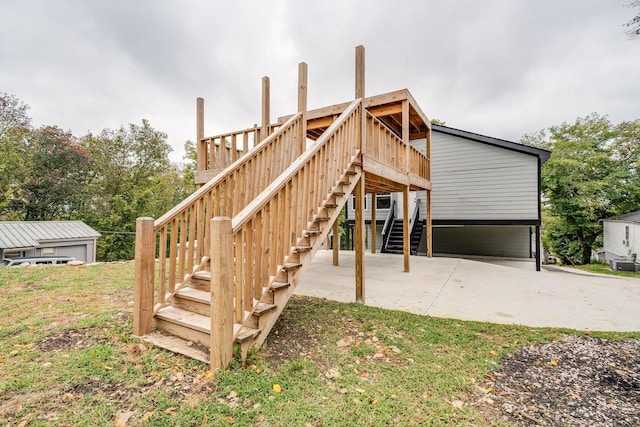 rear view of house featuring a patio area and a wooden deck