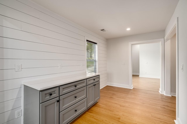 interior space featuring wood walls and light hardwood / wood-style flooring