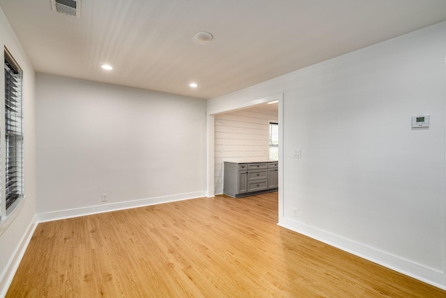 unfurnished room with light wood-type flooring