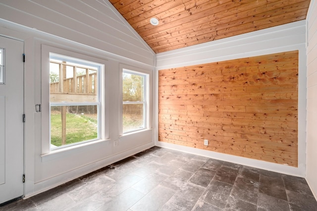 unfurnished room with wooden walls, plenty of natural light, wood ceiling, and lofted ceiling