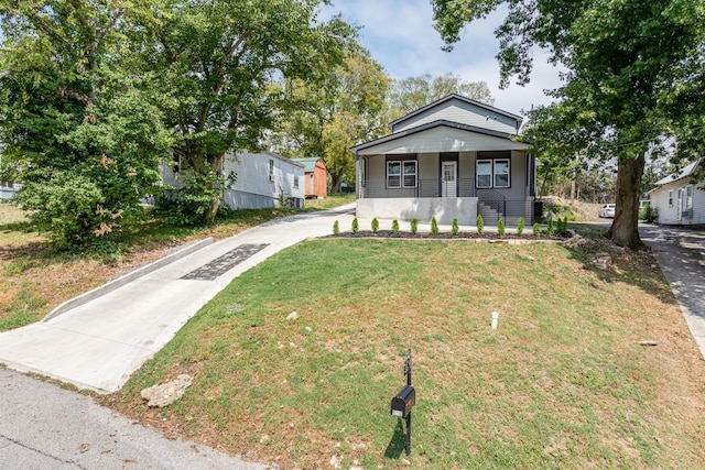 bungalow-style house with covered porch and a front yard