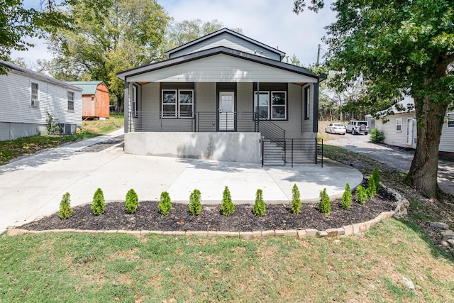 bungalow-style home featuring covered porch and central AC