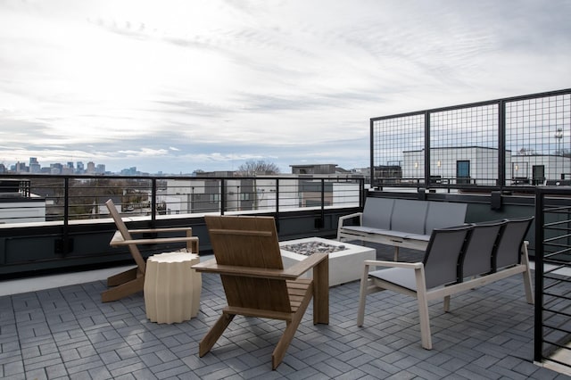 view of patio with an outdoor living space with a fire pit