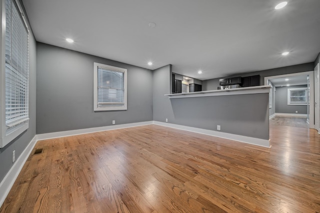 unfurnished living room with light hardwood / wood-style flooring