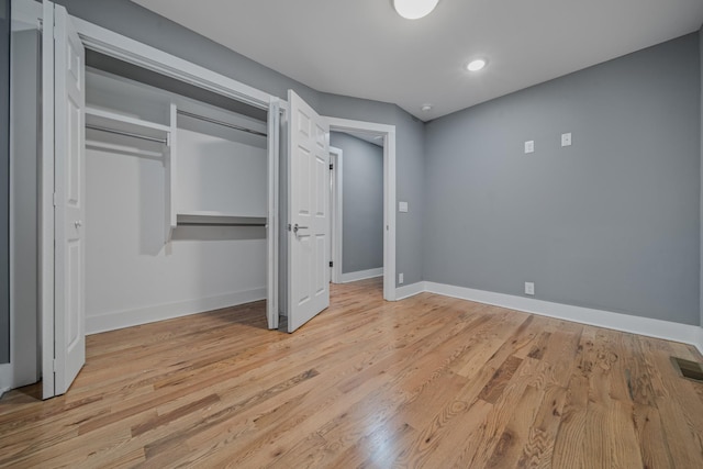 unfurnished bedroom with light hardwood / wood-style floors and a closet