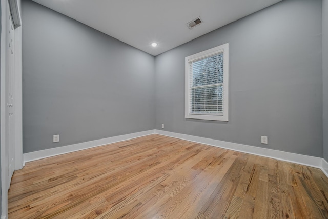 empty room with light hardwood / wood-style flooring