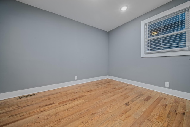 unfurnished room with light wood-type flooring