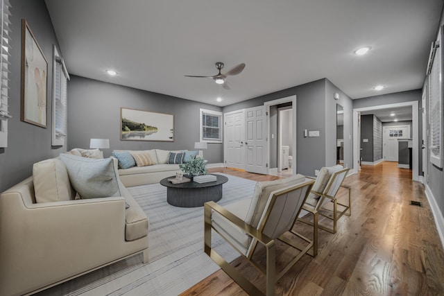 living room with hardwood / wood-style flooring and ceiling fan