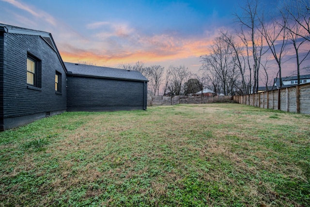 view of yard at dusk