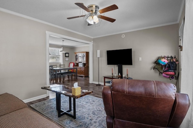 living room featuring dark hardwood / wood-style floors, ceiling fan, and ornamental molding