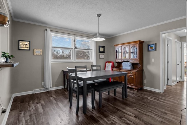 dining area featuring a textured ceiling, dark hardwood / wood-style floors, and crown molding