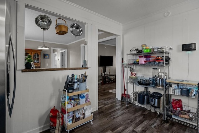 kitchen featuring stainless steel fridge, dark hardwood / wood-style flooring, a textured ceiling, and ornamental molding