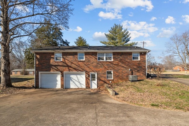 view of front of home featuring central AC and a garage