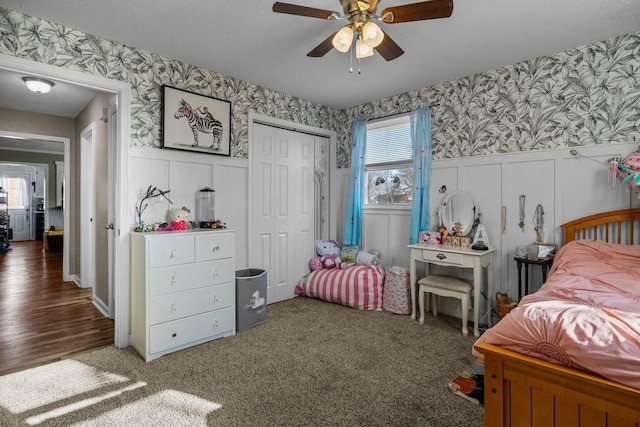 carpeted bedroom featuring ceiling fan and a closet