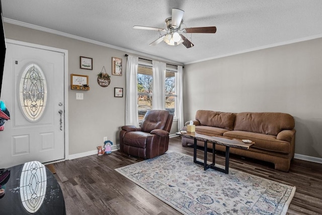 living room with crown molding, dark hardwood / wood-style flooring, ceiling fan, and a textured ceiling