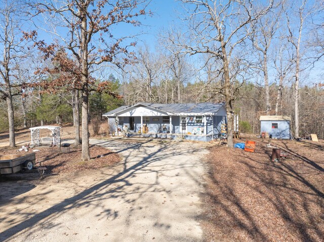 single story home with a shed and a porch