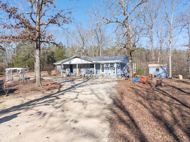 view of front of house with a shed and a porch