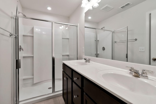 bathroom with tile patterned floors, vanity, and a shower with shower door