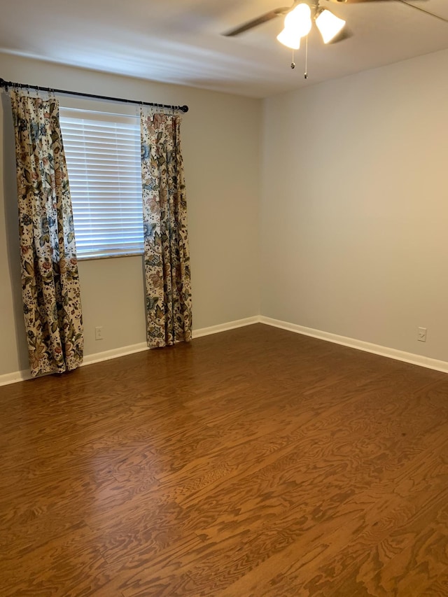 spare room with ceiling fan and dark hardwood / wood-style floors