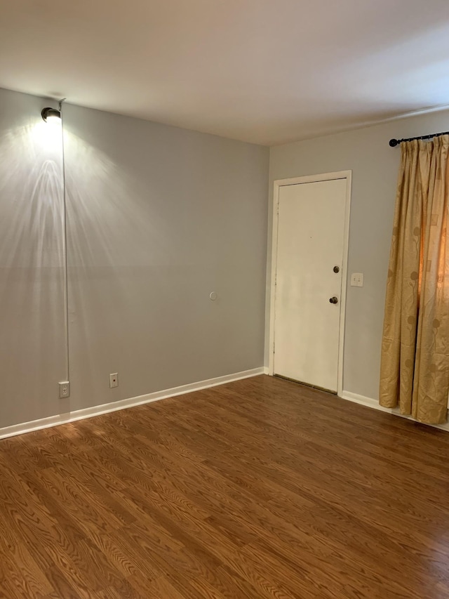 spare room featuring dark hardwood / wood-style flooring