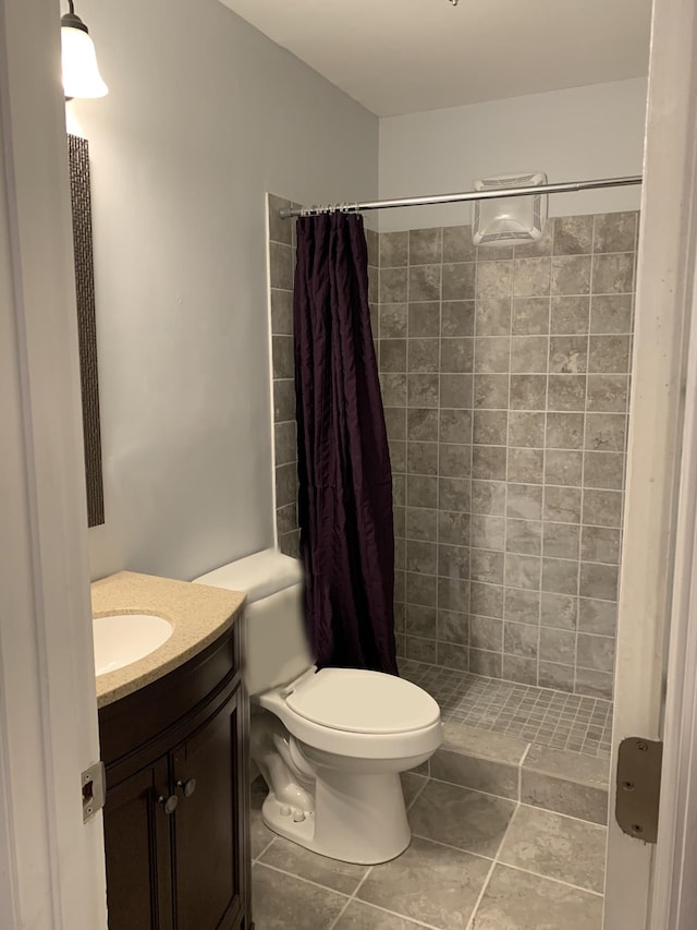 bathroom featuring a shower with curtain, vanity, tile patterned floors, and toilet