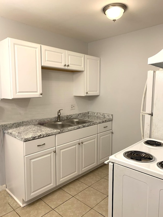 kitchen featuring sink, white cabinetry, light tile patterned floors, white appliances, and decorative backsplash