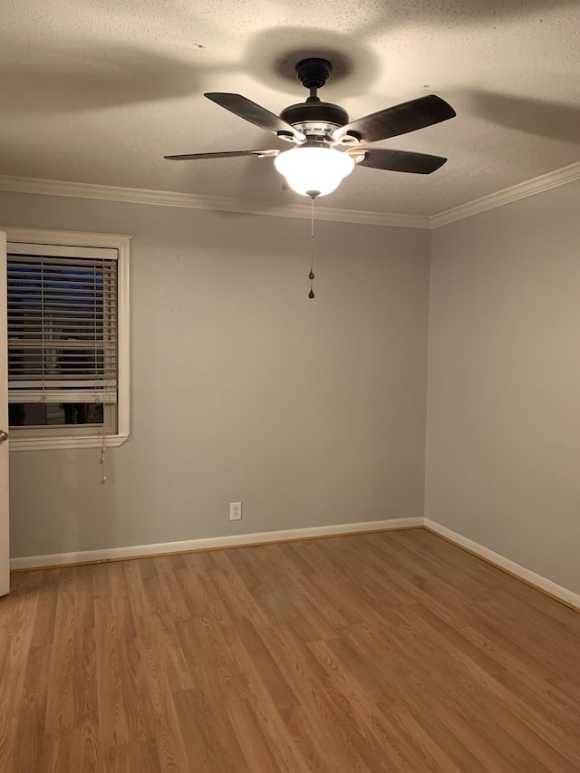 unfurnished room featuring hardwood / wood-style flooring, ceiling fan, a textured ceiling, and ornamental molding