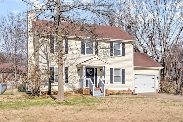 colonial inspired home featuring a garage and a front yard