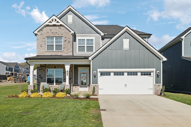 craftsman house with covered porch, a garage, and a front lawn