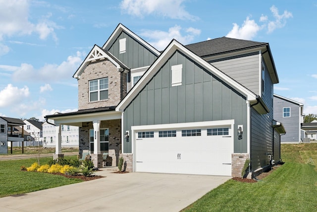 craftsman inspired home with covered porch, a garage, and a front yard