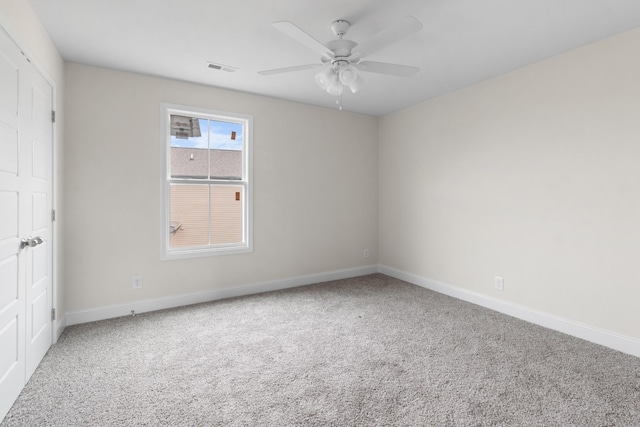 spare room with ceiling fan and carpet floors